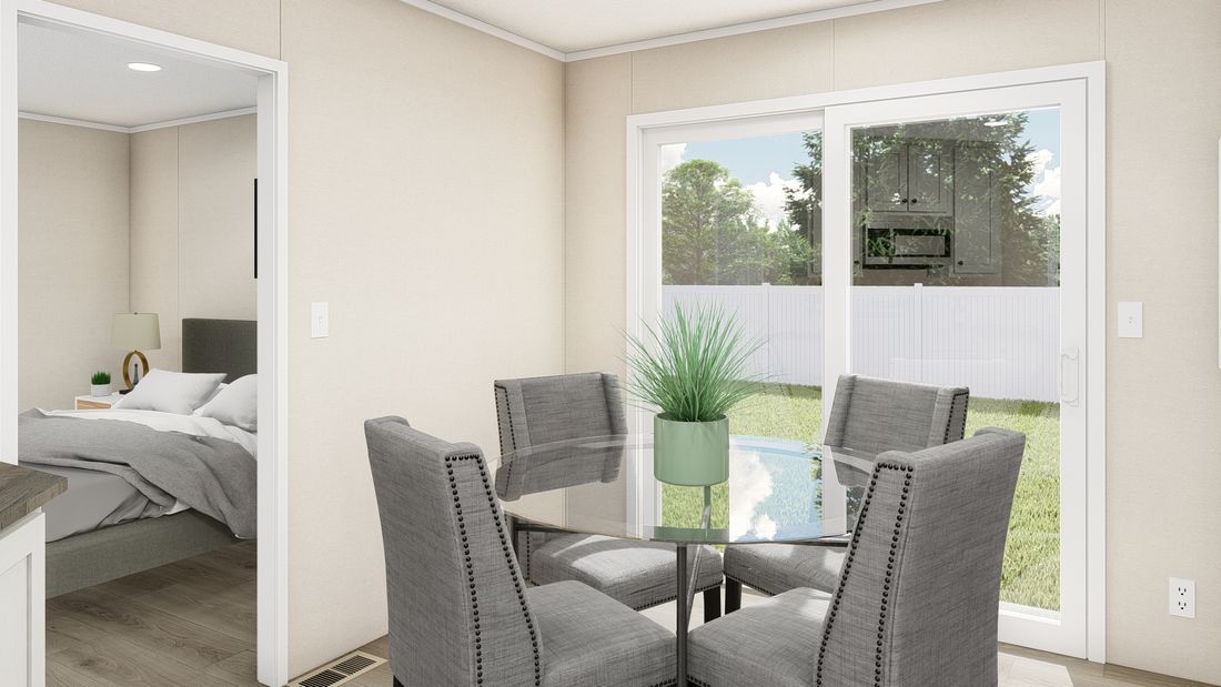 The THE ANNIVERSARY PLUS Dining Area. This Manufactured Mobile Home features 3 bedrooms and 2 baths.